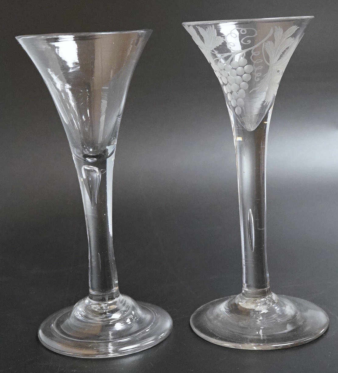 Two 18th century glass wine flutes, one with folded foot, tallest 16cm high